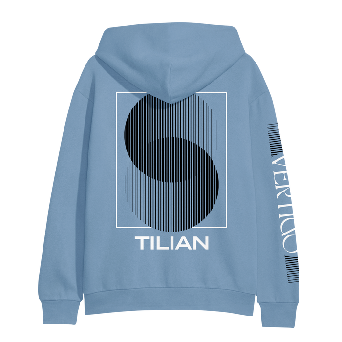 A light blue Tilian hoodie featuring a large abstract black S in a white rectangle on the back, TILIAN below, and VERTIGO vertically in white on the left sleeve.