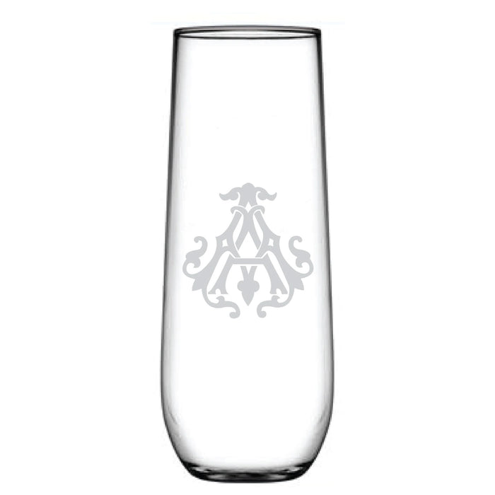A tall 1-Letter Monogrammed Stemless Champagne Flute features a clear glass with a centrally etched symmetrical emblem and an intricately engraved initial, exuding elegance.