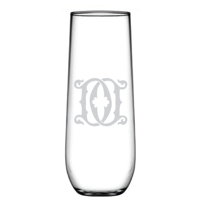 The tall, clear 1-Letter Monogrammed Stemless Champagne Flute boasts an elegant emblem etching in the center. Its sleek, cylindrical design with a stable base makes it perfect for stylishly serving beverages.