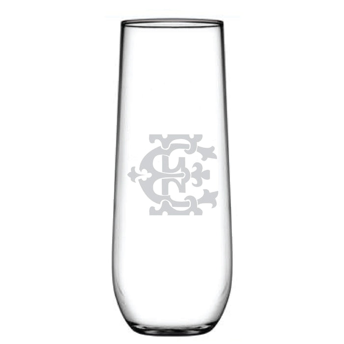 The 1-Letter Monogrammed Stemless Champagne Flute is a tall, clear glass with an intricately etched interlocking letter C design. Its sleek, cylindrical shape enhances the elegance of any beverage experience.