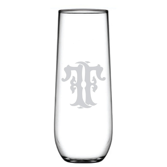 The 1-Letter Monogrammed Stemless Champagne Flute features a stylized letter T etched into its smooth, elegant surface, highlighting its clear and simple design.