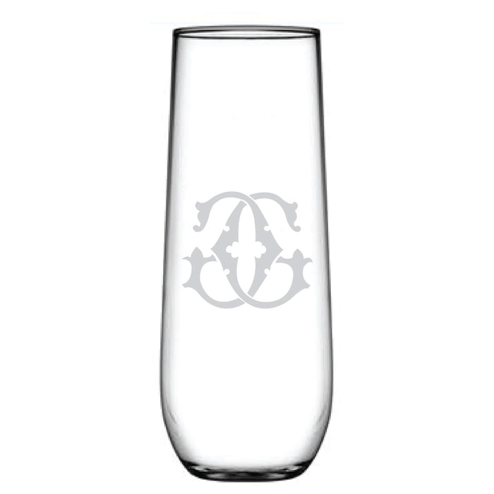 A clear 1-Letter Monogrammed Stemless Champagne Flute with a stylish etched design, showcasing a symmetrical ornate pattern in white and a personalized initial, all set against a plain white background.
