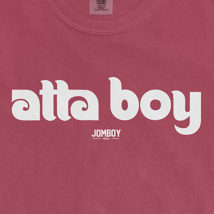 Pink Comfort Colors T-shirt with white "atta boy" text and a small "JOMBOY" logo below.
