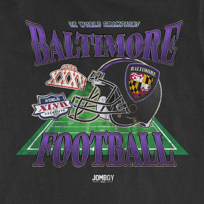 Black Comfort Colors T-shirt featuring a Baltimore football design with a helmet, football field, and championship logos.
