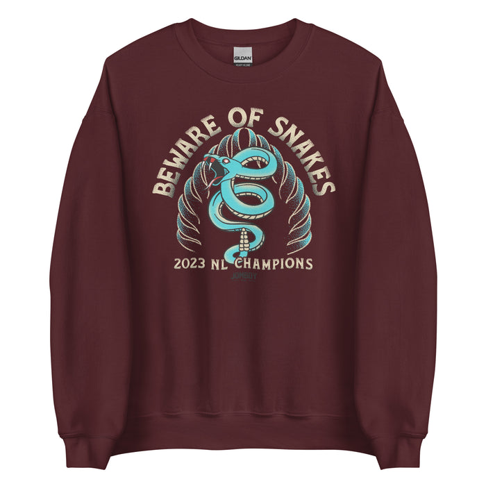 Maroon crewneck sweatshirt featuring a blue snake coiled around a snake head with the text "Beware of Snakes," celebrating 2023 NL Champions.
