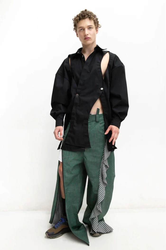 MANCANDY Crossed Garment Jacket featuring curved overlapping panels, exposed nickel buttons, shirt collar and water-repellent cotton-nylon construction.