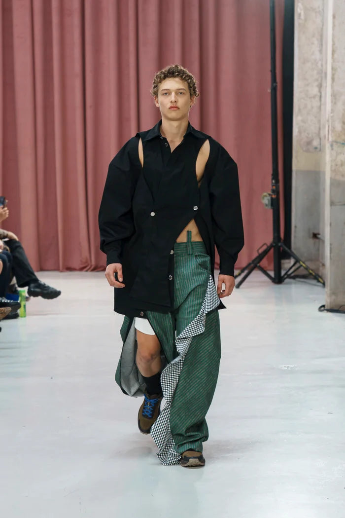 MANCANDY Crossed Garment Jacket featuring curved overlapping panels, exposed nickel buttons, shirt collar and water-repellent cotton-nylon construction.