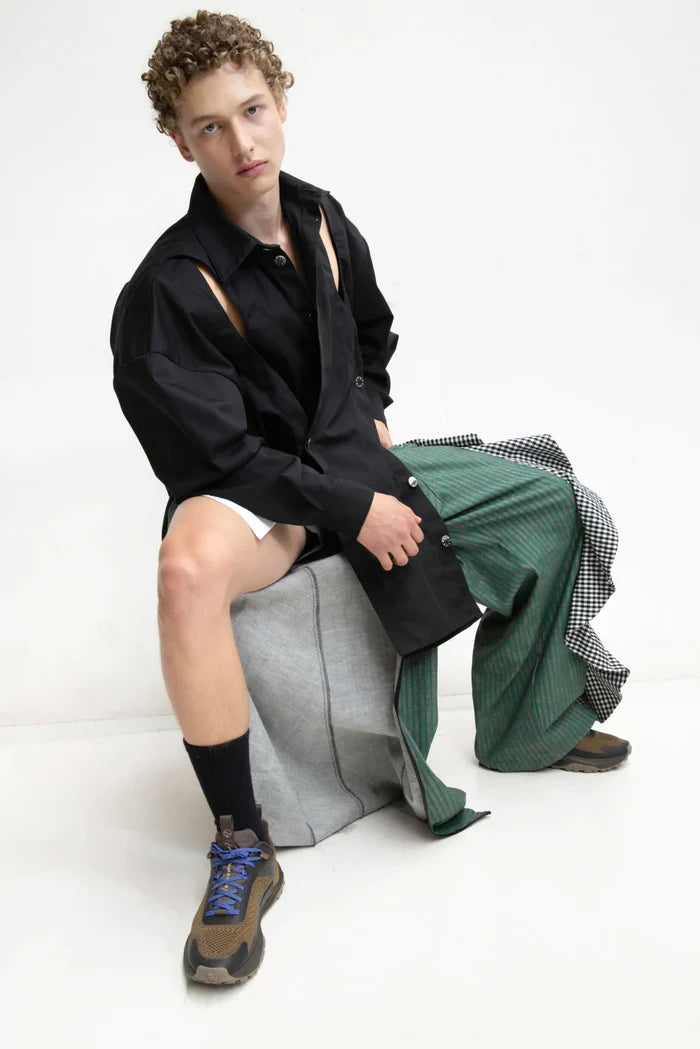 MANCANDY Crossed Garment Jacket featuring curved overlapping panels, exposed nickel buttons, shirt collar and water-repellent cotton-nylon construction.