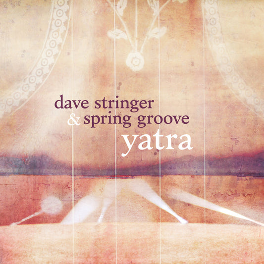 Album cover with soft, warm tones and abstract patterns. Text: Dave Stringer & Spring Groove Yatra. Light beams and ornate circular designs inspired by Jay Jay Ma Durga are subtly visible in the background.