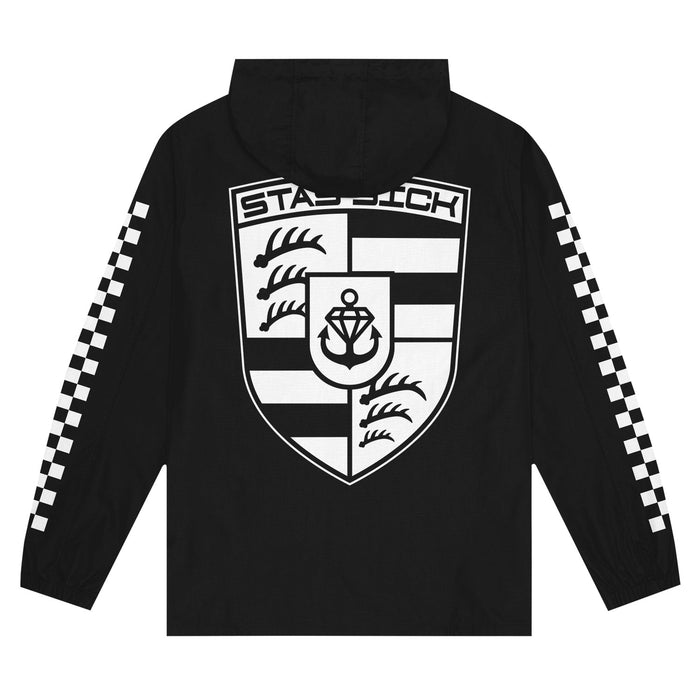 A black pullover windbreaker from Stay Sick Clothing features a large white crest with an anchor and waves on the back. Bold white checkerboard stripes run down both sleeves, adding signature style.