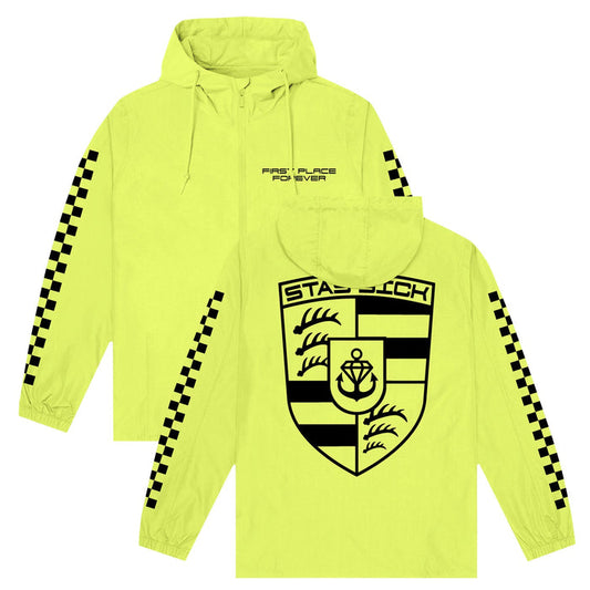 A bright Safety Yellow Pullover Wind Breaker by Stay Sick Clothing, featuring black checkerboard sleeve stripes, small FIRST PLACE FOREVER text on the front, and a bold STADIUM crest with anchor and waves on the back.