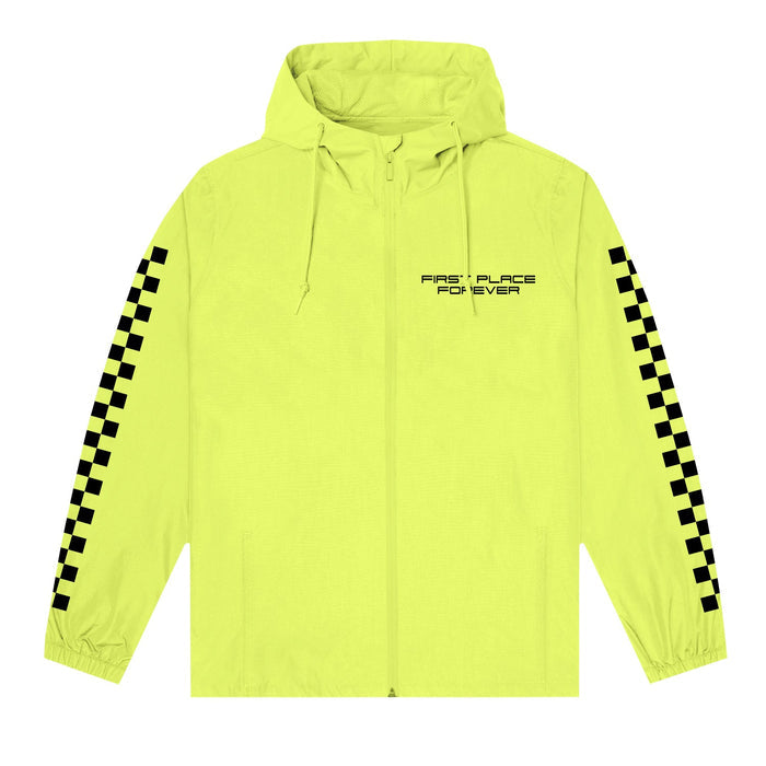 A Stay Sick Clothing Safety Yellow Wind Breaker features black checkered stripes on the sleeves and FIRST PLACE FOREVER printed on the left chest.