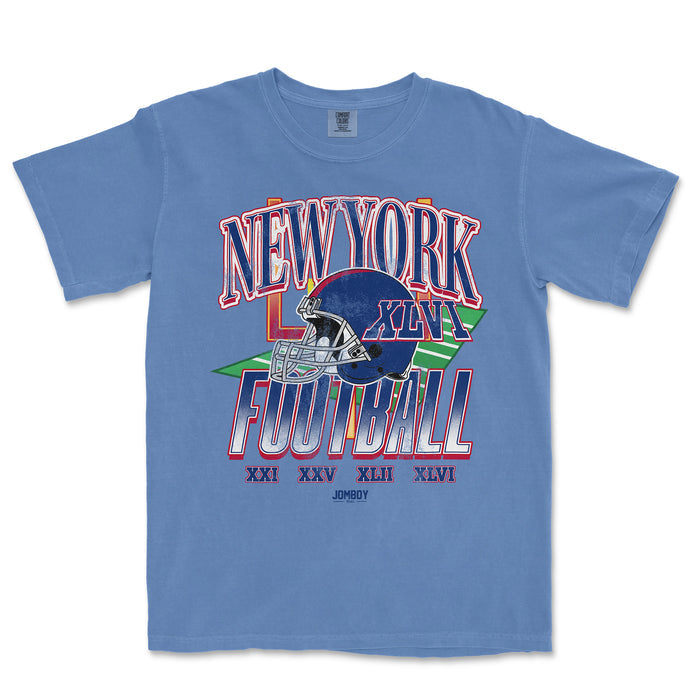 Blue vintage Comfort Colors® T-shirt featuring a colorful New York Giants football graphic with Roman numerals and team helmet design.
