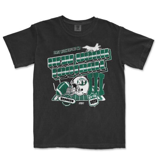 Black Comfort Colors® T-shirt featuring green and white New York Jets football graphics, helmets, and text celebrating East Rutherford, NJ.