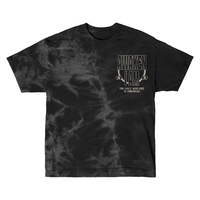 Awaken I Am black tie-dye t-shirt featuring beige AWAKEN I AM text on the chest with THE ONLY WAY OUT IS THROUGH underneath. The design has a slightly worn, vintage look.