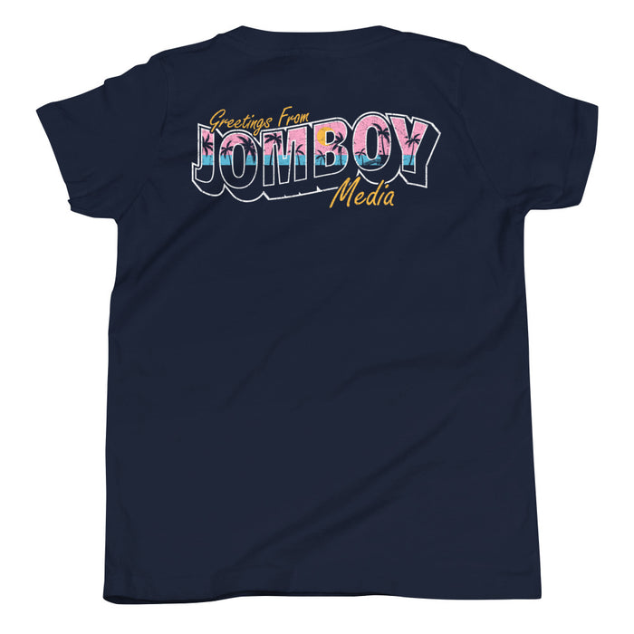 Back of navy youth T-shirt with "Greetings from Jomboy Media" in colorful, bold, and stylized text.