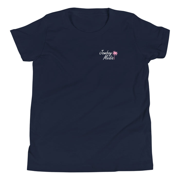 Navy youth T-shirt with "Greetings from Jomboy Media" text and pink palm tree graphic on the chest.