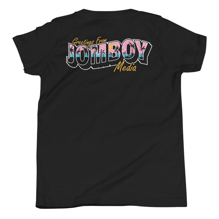 Black youth T-shirt with colorful "Greetings from Jomboy Media" text and yellow cursive accents.
