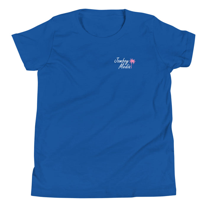 Blue youth T-shirt with "Jomboy Media" text and pink palm tree graphic on the front left chest.
