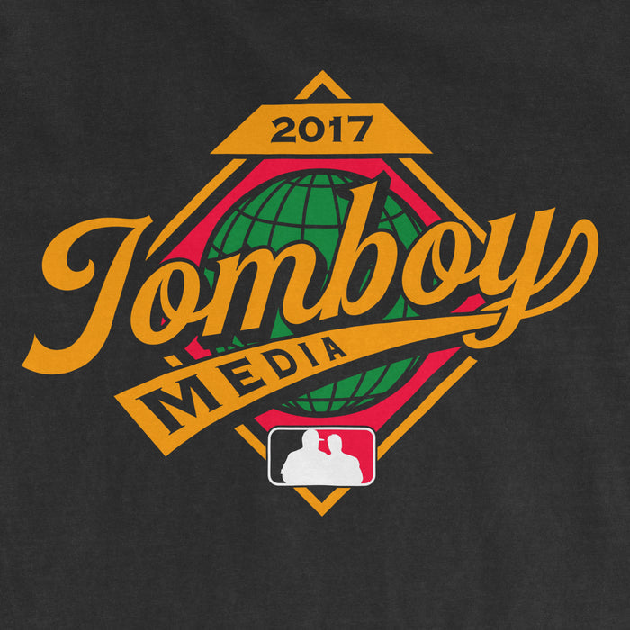 Black Comfort Colors T-shirt featuring a colorful "Jomboy Media" logo with a globe, "2017" and MLB silhouette design.