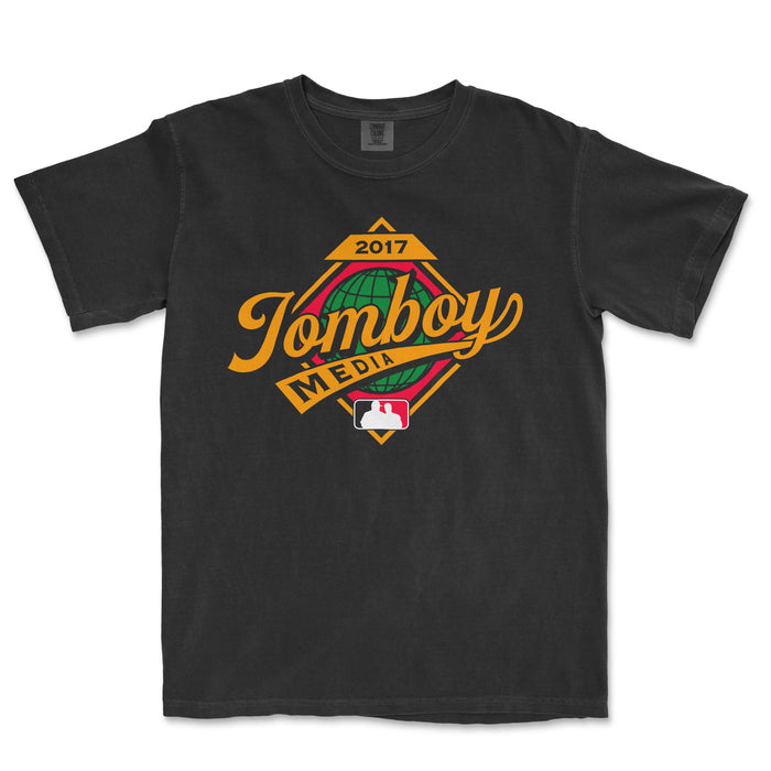 Black Comfort Colors T-shirt featuring a colorful "Jomboy Media" logo with a globe, baseball, and "2017" text for fall event.
