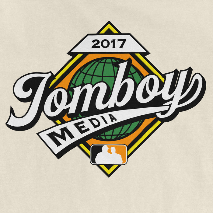 Comfort Colors T-shirt featuring a colorful "Jomboy Media" logo with a globe, banner, and MLB silhouette, from the 2017 Fall Classic.