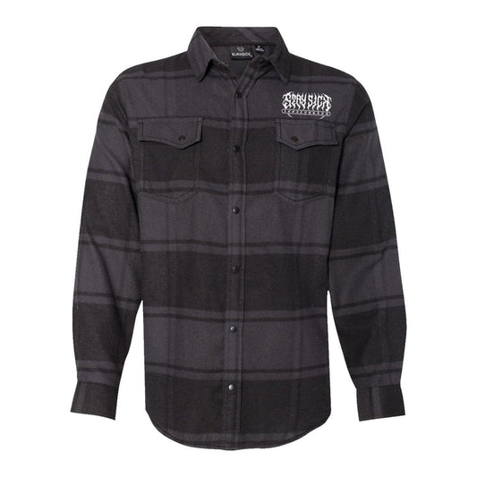 A black and dark gray plaid Stay Sick Clothing flannel shirt featuring long sleeves, two chest pockets, and a white graphic logo on the left chest.