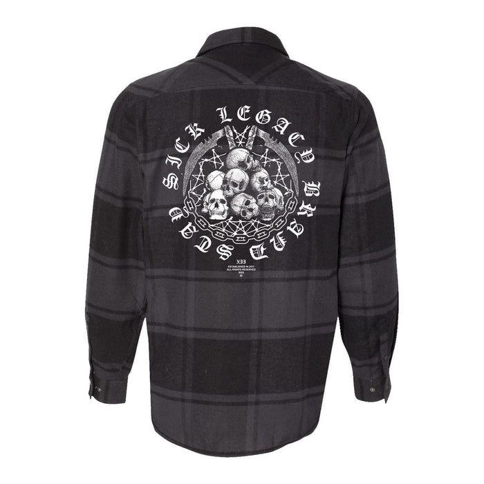 A black and gray plaid Stay Sick Clothing flannel shirt featuring a large back graphic with skulls, barbed wire, and crossed bats. The design includes the text SICK LEGACY BRAND.