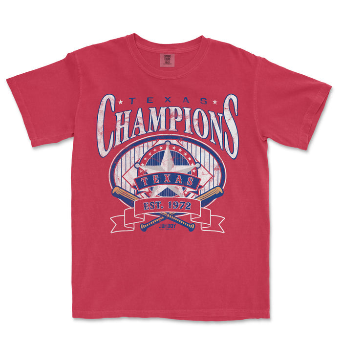 Red Comfort Colors tee featuring a vintage-style "Long Time Comin'" Texas Champions design with a star, baseball bats, and "EST. 1972" text.
