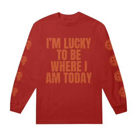 This Gorilla Biscuits Red Long Sleeve is a statement piece with bold IM LUCKY TO BE WHERE I AM TODAY text on the front, plus repeating skull and G circle graphics down each sleeve—capturing the true Lucky To Be vibe.