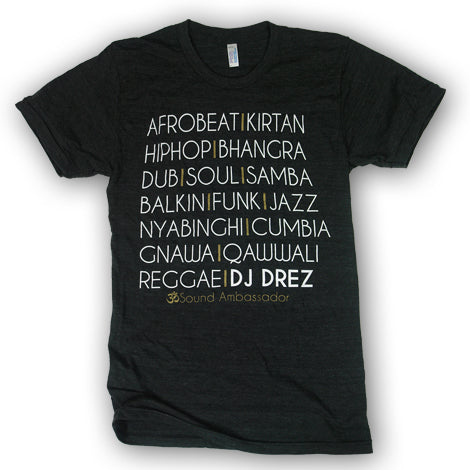 The Mantralogy black t-shirt features white text listing music genres like Afrobeat, Kirtan, Hip Hop, Bhangra, Dub, Funk, Jazz, Reggae and DJ Drez in bold.