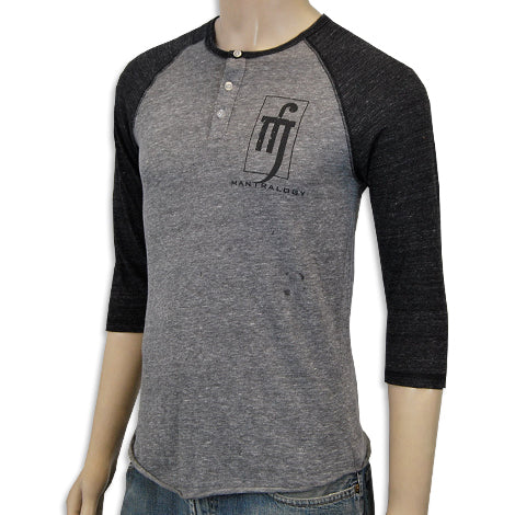 A mannequin wears a Mantralogy gray raglan three-quarter sleeve henley with black sleeves, buttoned collar, stylized M logo, and MANTRALOGY text on the chest.