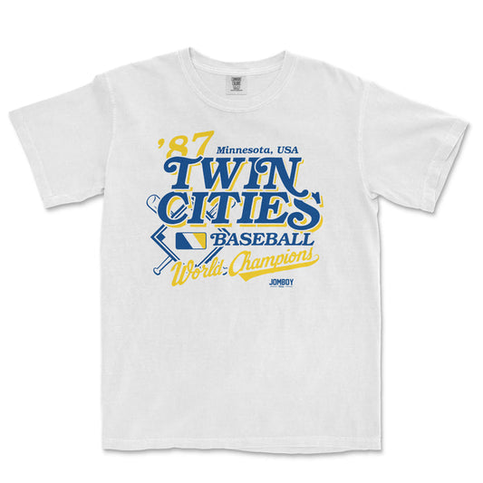 White Comfort Colors tee featuring vintage Minnesota Twins baseball design with blue and yellow text and graphics.