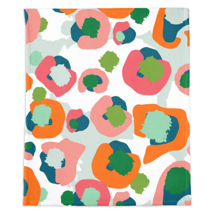 The Multi Spot Cheetah Minky Blanket showcases a vivid abstract design with overlapping shapes in hues of pink, orange, green, and teal set against a white backdrop. Reminiscent of organic forms or splotches, this lively pattern graces an ultra-soft blanket made from microfiber polyester for enhanced comfort.