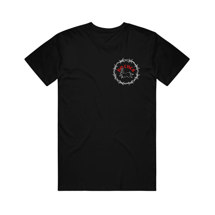 Stay Sick Clothing black T-shirt with a small red and white No Luck graphic—barbed wire circle, stylized text, and figure—on the left chest. Shirt is laid flat on a white background.