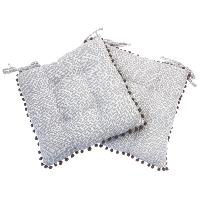 Grey and white diamond pattern set of 2 chair cushions with dark grey pom pom fringe