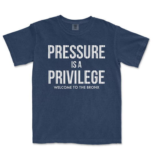Blue T-shirt with white text that reads "Pressure is a Privilege. Welcome to the Bronx.