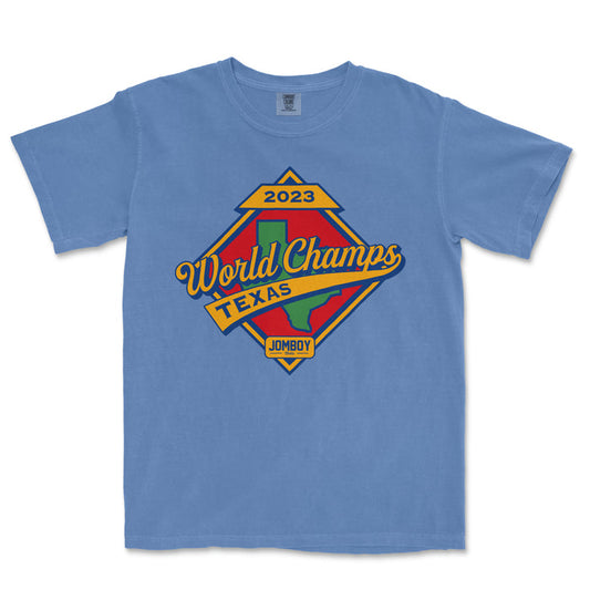 Blue T-shirt featuring a colorful vintage-style graphic celebrating the 2023 World Champs in Texas, with a Texas map and JomboY logo.