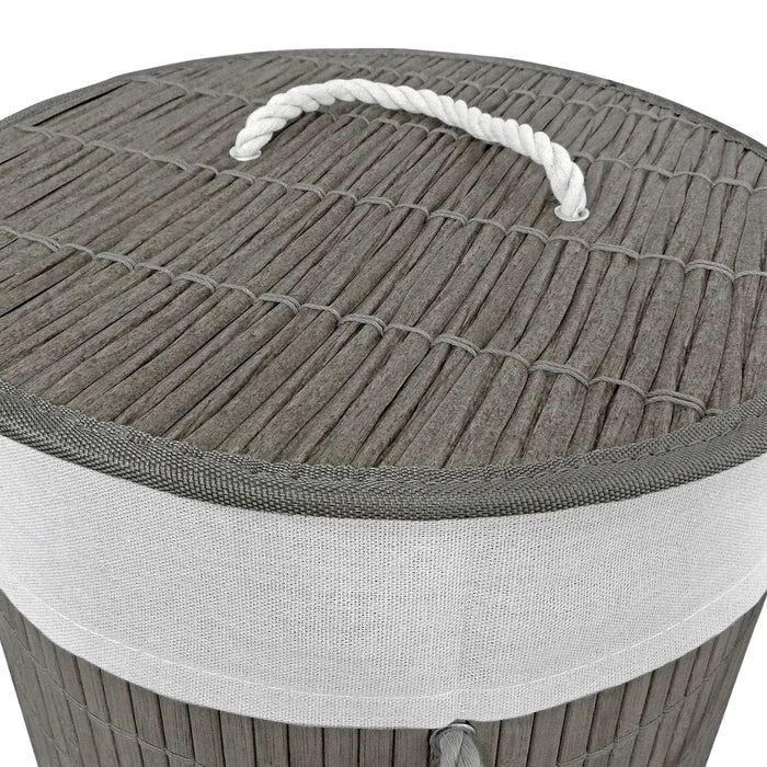 Details of rattan effect lid with white rope handle on a grey bamboo laundry basket on