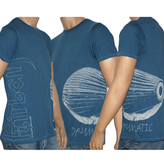Three mannequin torsos display a blue Mantralogy t-shirt with white artistic drum prints, the text DRUMATIC, and stylized writing along the side. The shirt is featured from left, front, and right angles.