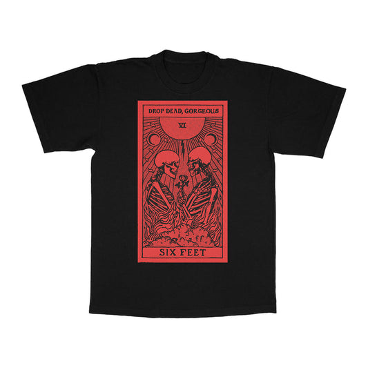 Drop Dead, Gorgeous black t-shirt with large red graphic of two skeletons, rays, and moons. Features “DROP DEAD,” “GORGEOUS,” “VI,” and “SIX FEET.” Made from ring-spun cotton for a modern classic fit. Inspired by Gildan Softstyle T-Shirts.