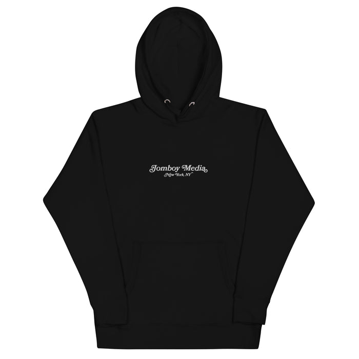 Black embroidered hoodie with "Jomboy Media" and "New York, NY" text on the front, featuring a drawstring hood and front pocket.