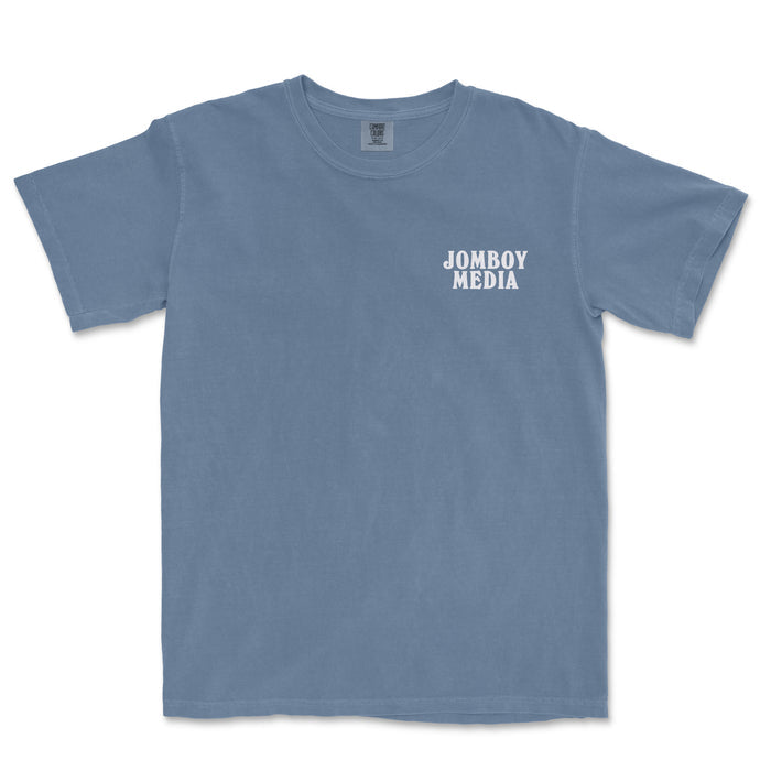 A blue T-shirt with "JOMBOY MEDIA" printed in white text on the front left chest area.
