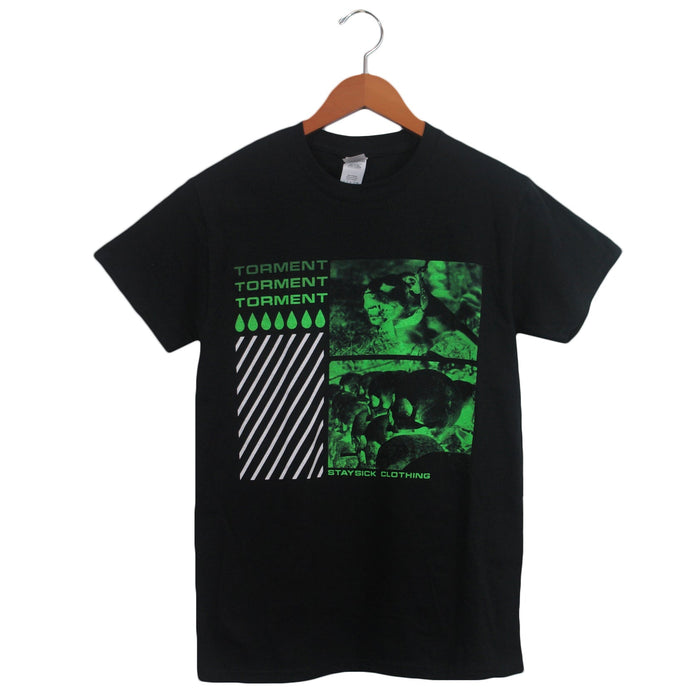 Stay Sick Clothing’s Torment Black T-shirt, shown on a hanger, features green and white TORMENT text, diagonal stripes, raindrop motifs, two green-tinted photos, and STAY SICK CLOTHING printed at the bottom.