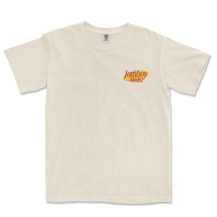 Cream-colored T-shirt with a small "Jomboy Media" logo in red, yellow, and blue on the upper left chest area.