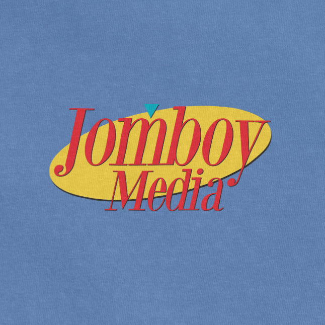 "UWS Special product featuring Jomboy Media logo with red text, yellow background, and blue and red accents on a blue fabric.