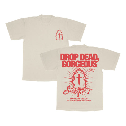Drop Dead, Gorgeous beige Gildan Softstyle T-shirt in ring-spun cotton (modern classic fit). Red front graphics: small mirror and cross; back has bold DROP DEAD, GORGEOUS text above a large mirror, cross, and additional graphics.