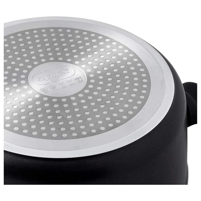 Base of a large black stock pot with circular pattern to distribute heat evenly